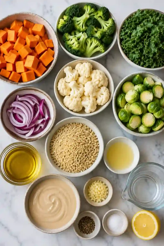 A vibrant Roasted Vegetable Quinoa Bowl with roasted broccoli, cauliflower, sweet potatoes, Brussels sprouts, quinoa, and fresh kale finished with lemon tahini dressing.
