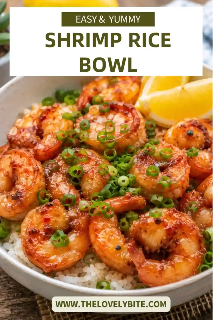 A Shrimp Rice Bowl topped with garlic butter shrimp, chopped scallions, and fresh lemon wedges served over fluffy white rice. The glossy soy butter glaze adds rich color and flavor.