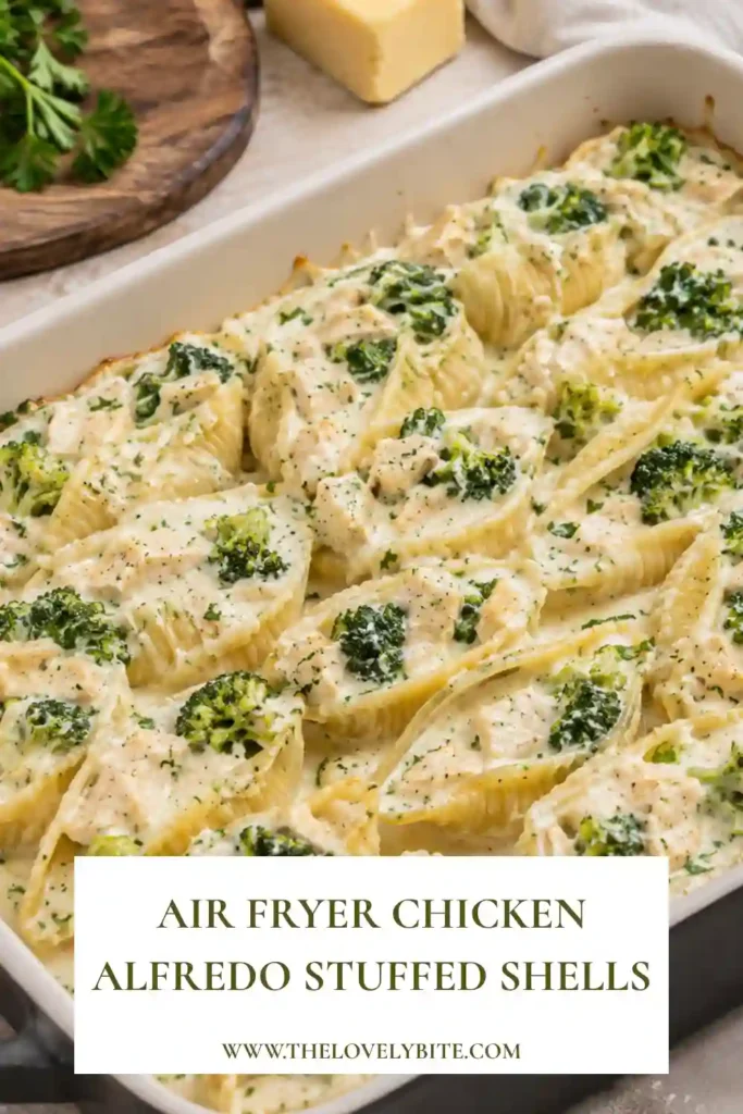 Close-up of chicken Alfredo stuffed shells with creamy ricotta filling, broccoli, mozzarella, and Parmesan. The air-fried pasta shells are coated in Alfredo sauce and finished with melted cheese.