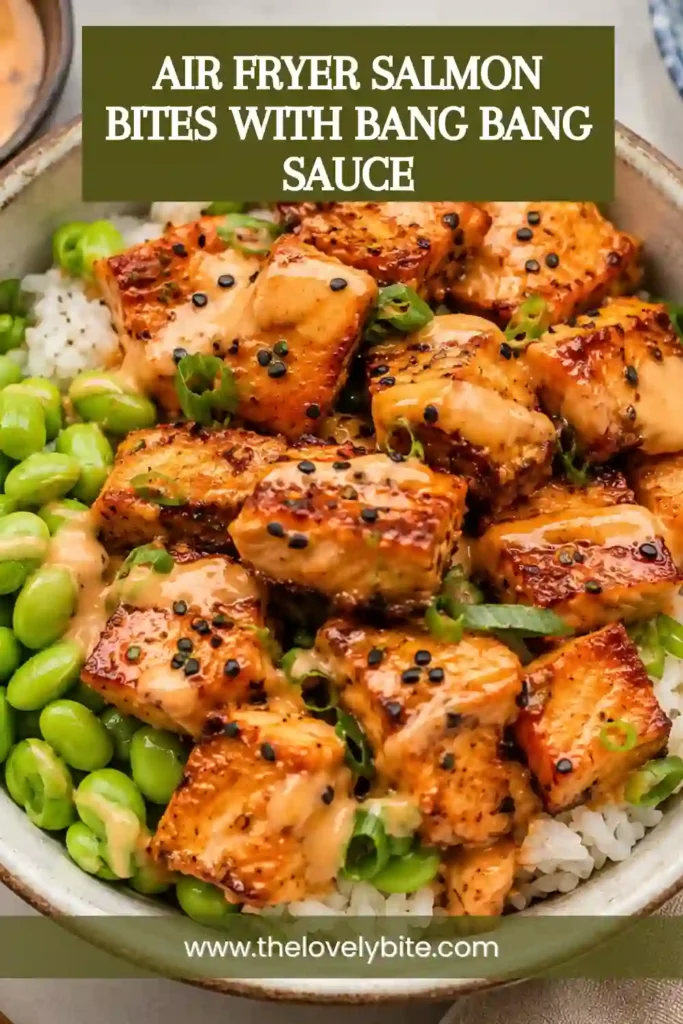 1. Air Fryer Salmon Bites served with creamy bang bang sauce and fresh lemon. The bite-sized salmon pieces have golden caramelized edges and a tender, flaky center.