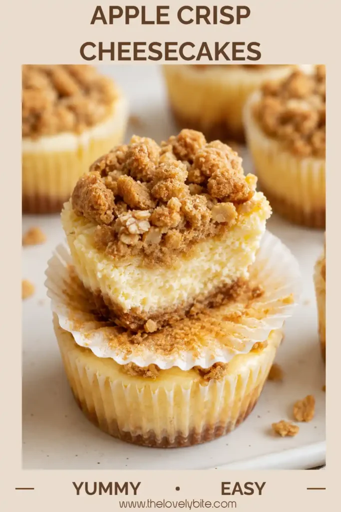 Mini apple cheesecakes topped with tender apple pieces and crunchy brown sugar cinnamon streusel. A sliced cheesecake reveals the creamy filling and graham cracker crust.