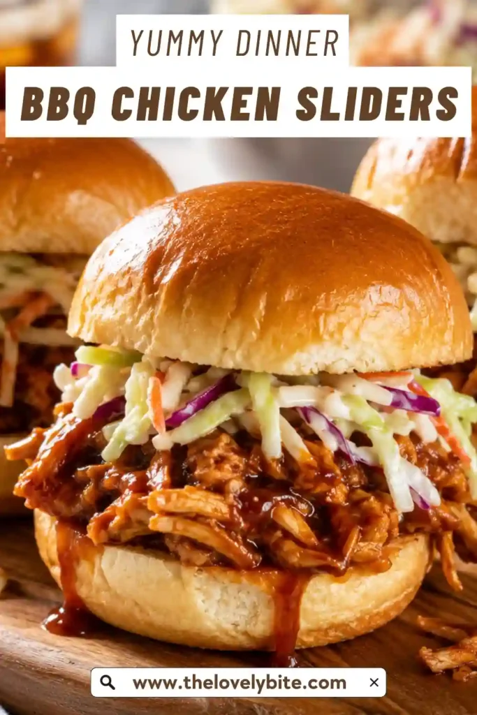 A serving platter filled with homemade BBQ Chicken Sliders featuring juicy chicken, barbecue sauce, melted cheese, and soft buttery buns. Perfect for entertaining guests.