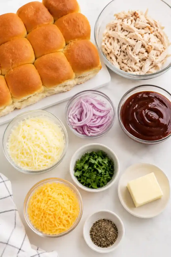 Freshly baked BBQ Chicken Sliders filled with shredded chicken, smoky barbecue sauce, melted mozzarella, smoked Gouda, and red onion on soft golden slider buns. These cheesy baked sliders are perfect for parties and family dinners.