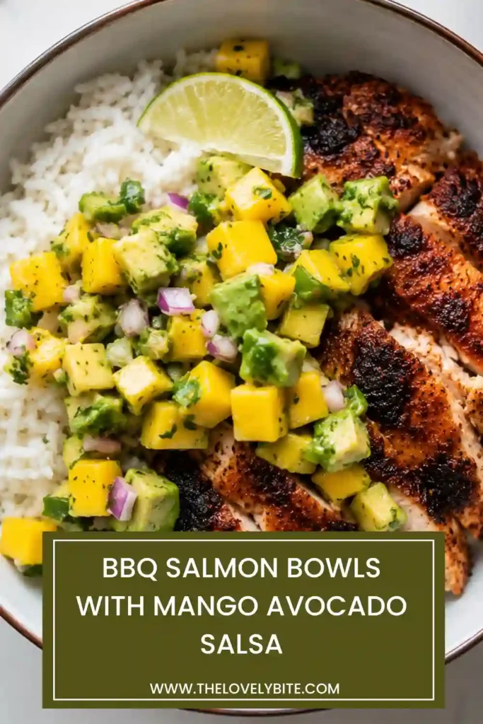 Homemade BBQ Salmon Bowls served with sweet mango avocado salsa and fluffy rice. The dish showcases golden salmon, ripe mango, creamy avocado, fresh cilantro, and lime.