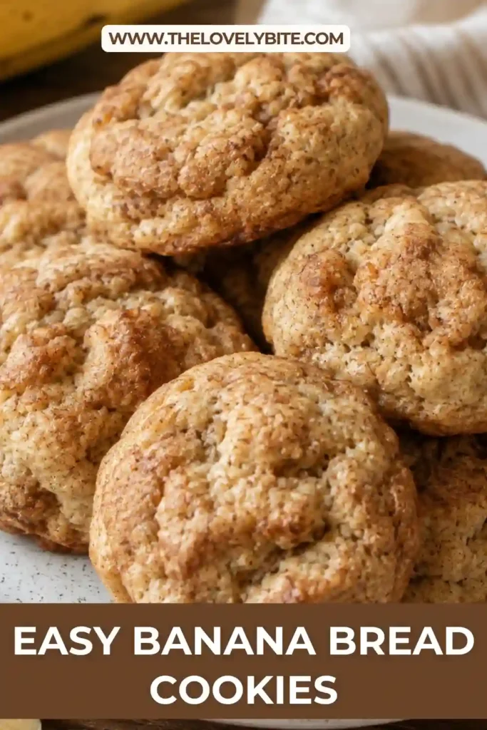 Banana Bread Cookies with soft golden centers, lightly browned edges and a tender banana bread texture. Fresh ripe bananas and cinnamon are arranged beside the homemade cookies.