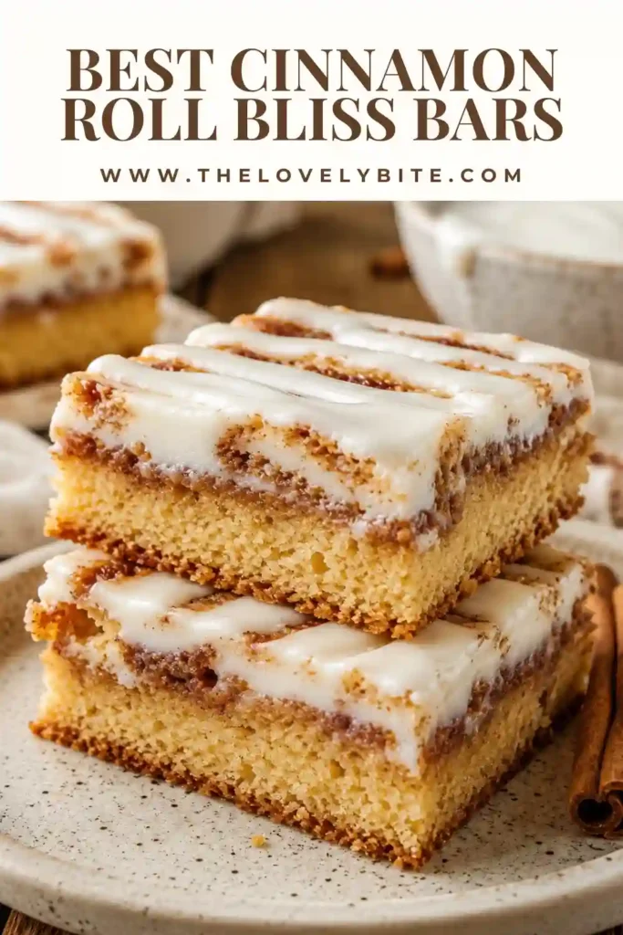 Cream cheese cinnamon bars with a soft vanilla cake base, buttery cinnamon swirl and glossy vanilla icing. The bars are cut into neat squares for serving.