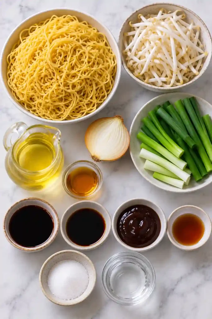 Cantonese Chow Mein served in a shallow bowl with crisp-chewy egg noodles, fresh sprouts and green onions. The easy Chinese-inspired noodle dish is coated in a rich savory sauce.
