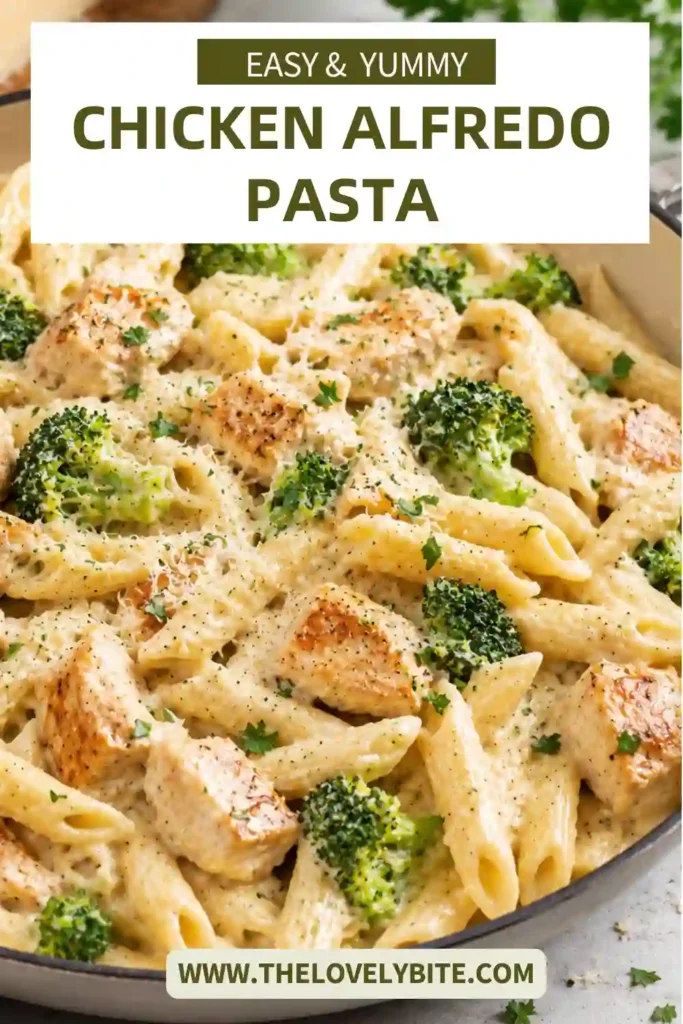 A serving of creamy chicken pasta featuring golden chicken pieces, penne, and thick Parmesan Alfredo sauce. The dish is garnished with parsley and freshly grated Parmesan.
