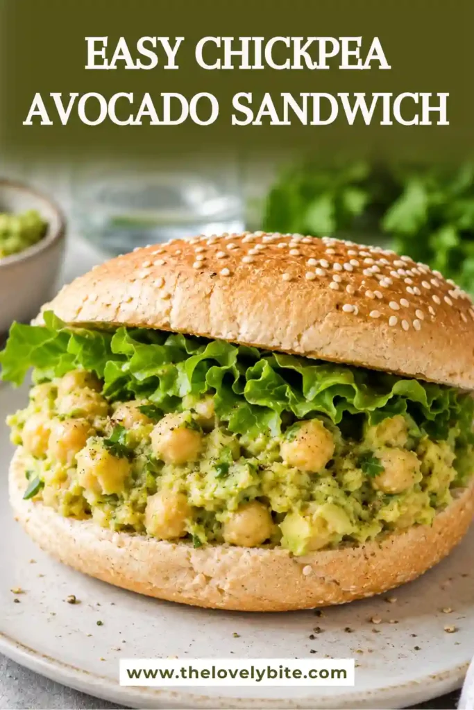 Close-up of a chickpea avocado sandwich filled with a creamy avocado chickpea salad and crunchy dill pickles. Fresh dill and green onions add vibrant color to the flavorful sandwich filling.