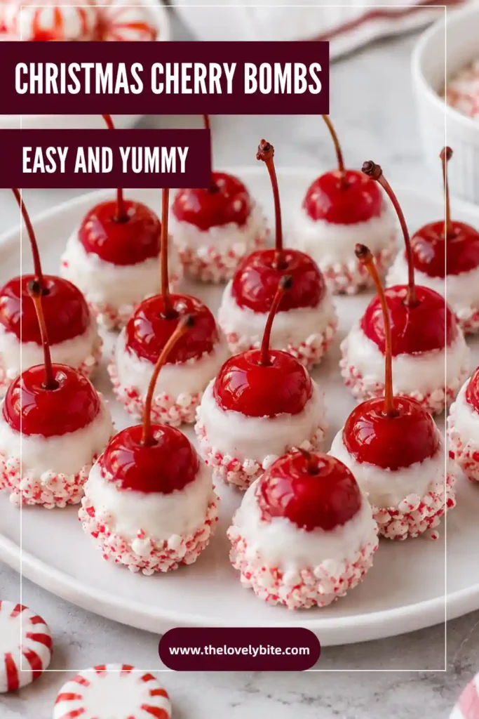 Homemade Christmas Cherry Bombs displayed on a parchment-lined tray with white chocolate and crushed peppermint candy. The easy Christmas candy has red cherry centers and decorative stems.