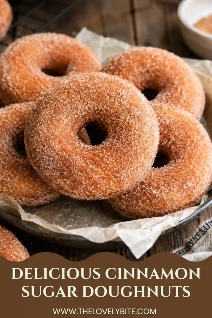 Fresh Cinnamon Sugar Doughnuts arranged on a cooling rack with a generous coating of cinnamon and sugar. The golden homemade doughnuts have soft, fluffy centers and crisp fried edges.