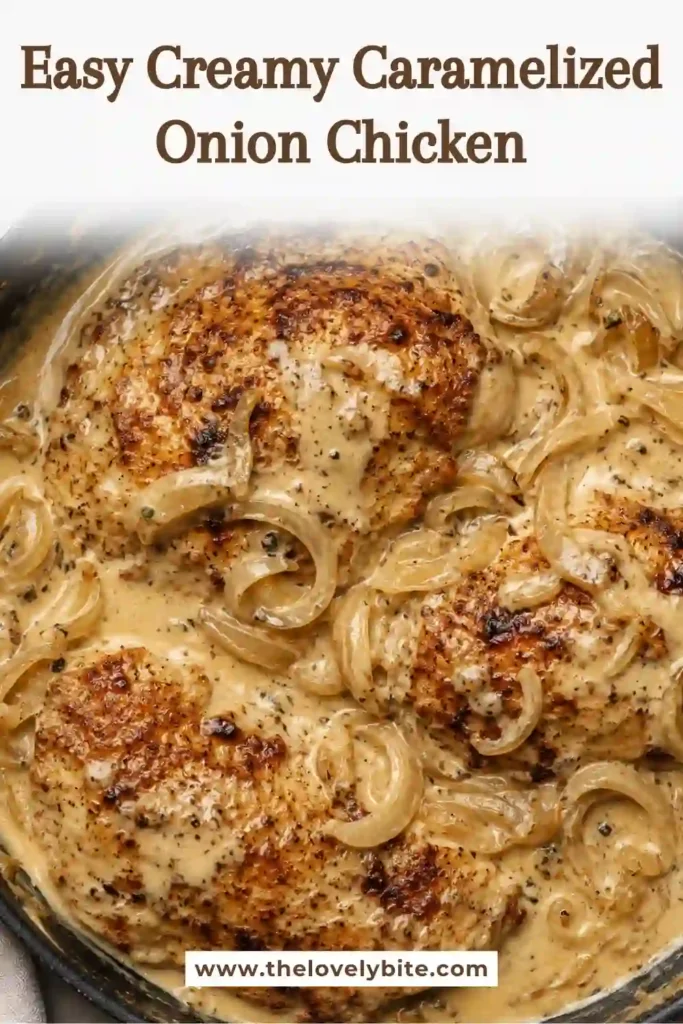 A skillet of creamy caramelized onion chicken with golden onions and a smooth Parmesan cream sauce. The tender chicken is surrounded by a rich, savory sauce.