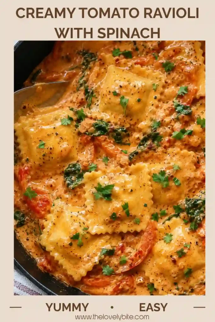 Creamy tomato ravioli dinner garnished with fresh parsley and Parmesan, with roasted cherry tomatoes and spinach visible throughout the sauce. The tender ravioli is coated in a smooth, flavorful tomato cream sauce.