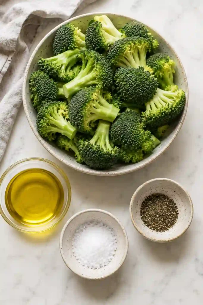 Crisp-tender broccoli florets fresh from the air fryer with lightly charred edges. This easy air fried broccoli is seasoned simply with olive oil, kosher salt, and black pepper.