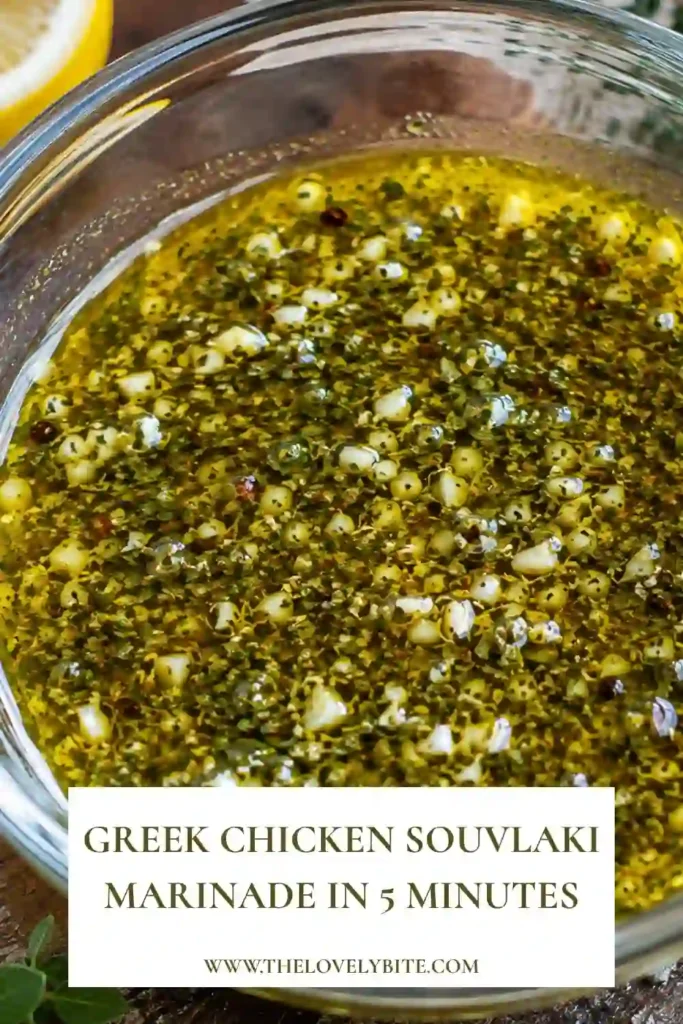 Greek Chicken Souvlaki Marinade coating pieces of chicken in a container with lemon, garlic, oregano, and olive oil. The chicken is ready to marinate for a flavorful Mediterranean meal.