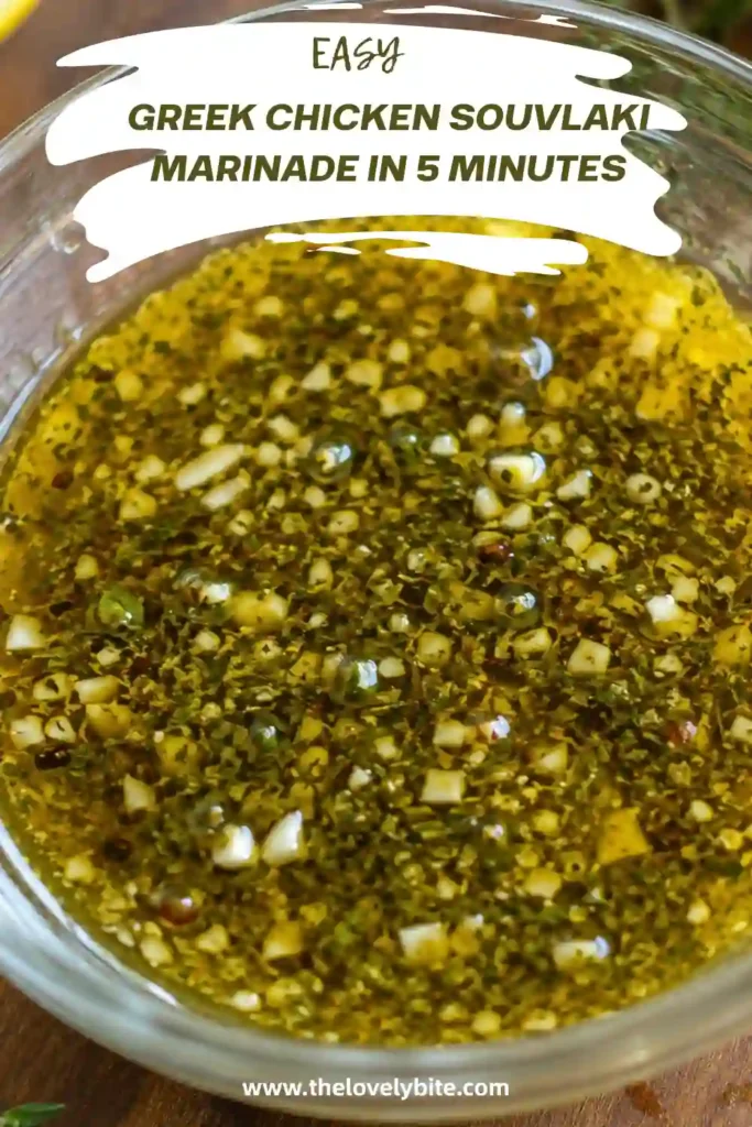 Greek Chicken Souvlaki Marinade prepared with lemon zest, lemon juice, garlic, oregano, olive oil, and vinegar. Fresh Mediterranean ingredients surround the finished marinade for a rustic Greek-inspired presentation.