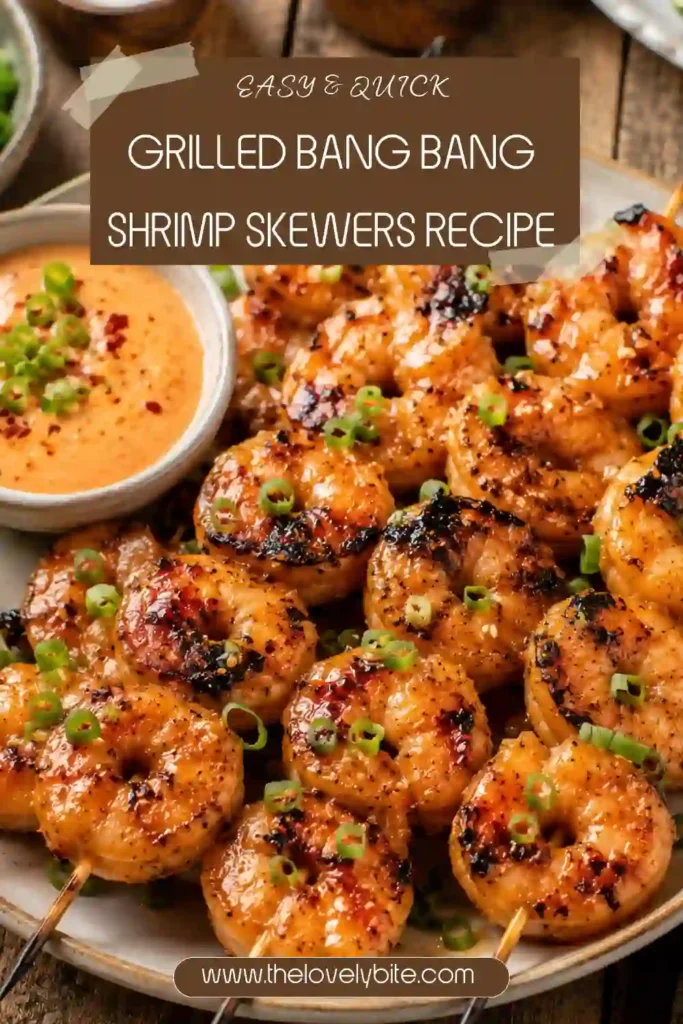 Close-up of grilled shrimp skewers coated in creamy bang bang sauce with fresh scallion garnish. The shrimp have beautiful grill marks and a juicy texture.