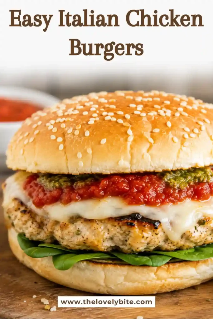 Italian Chicken Burgers served on toasted hamburger buns with melted mozzarella, marinara sauce, pesto, and fresh greens. The juicy ground chicken patties are seasoned with Parmesan cheese and Italian herbs.
