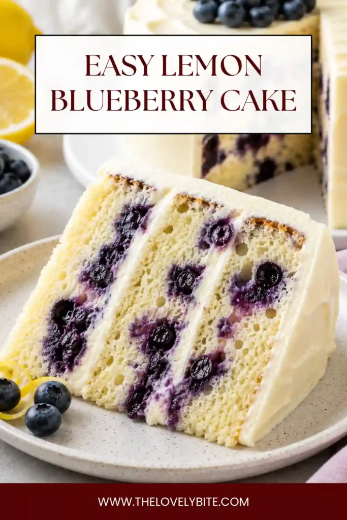 Lemon Blueberry Layer Cake decorated with smooth cream cheese frosting, fresh blueberries, and lemon slices. The tall homemade cake has soft layers filled with blueberries.