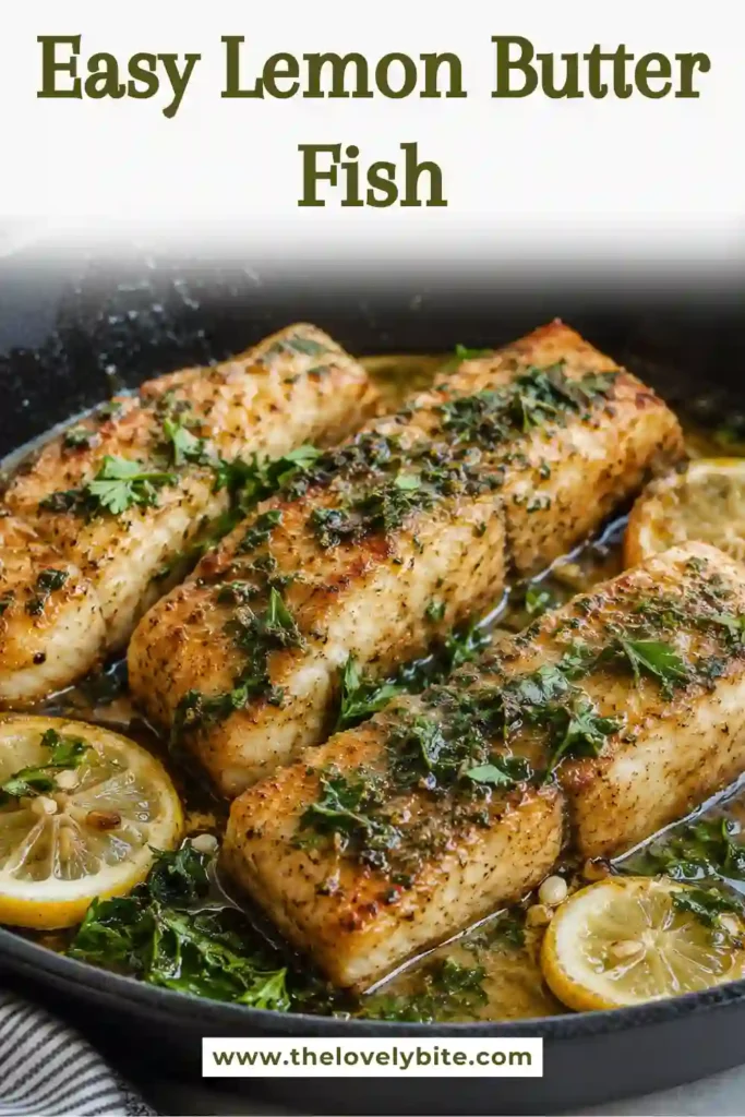 Lemon butter fish fillets served in a skillet with fresh lemon slices and parsley. The golden pan-seared fish is coated in a glossy lemon butter sauce.