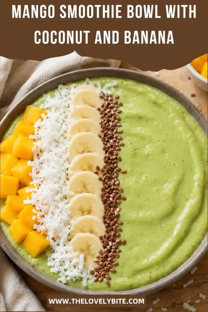 Tropical mango banana smoothie bowl topped with fresh fruit, shredded coconut, seeds, and almonds. Frozen mango and banana create a thick and creamy breakfast bowl.