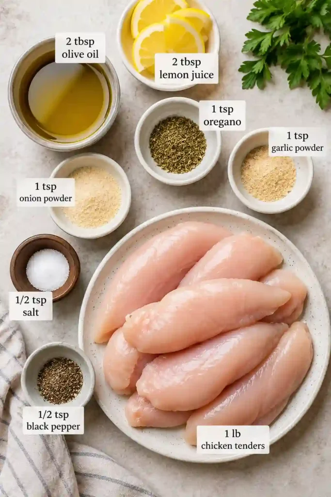 Healthy Mediterranean Chicken Tenders plated with lemon slices and fresh parsley for a colorful presentation. The chicken looks juicy with lightly crisp edges.