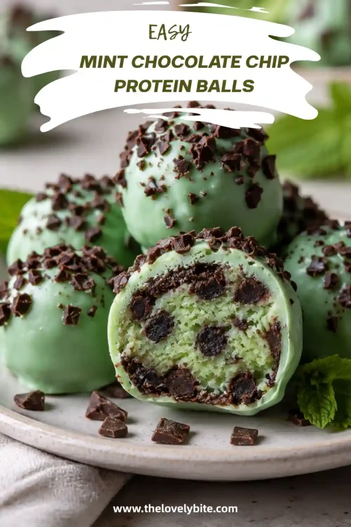 Mint Chocolate Chip Protein Balls with pale green chocolate coating and mini chocolate chips on top. One protein ball is cut open to show the soft cashew and chocolate chip center.