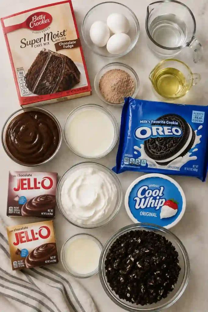 Oreo pudding cake topped generously with crushed chocolate sandwich cookies. The rich chocolate dirt cake has moist cake, fudgy filling, and a fluffy cookies-and-cream layer.