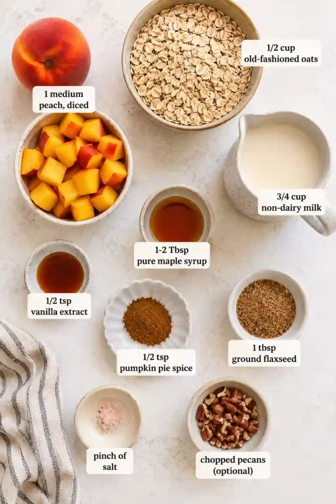 A glass jar filled with creamy Peach Cobbler Overnight Oats topped with fresh diced peaches and chopped pecans. This healthy overnight oats recipe is perfect for meal prep breakfasts and busy mornings.