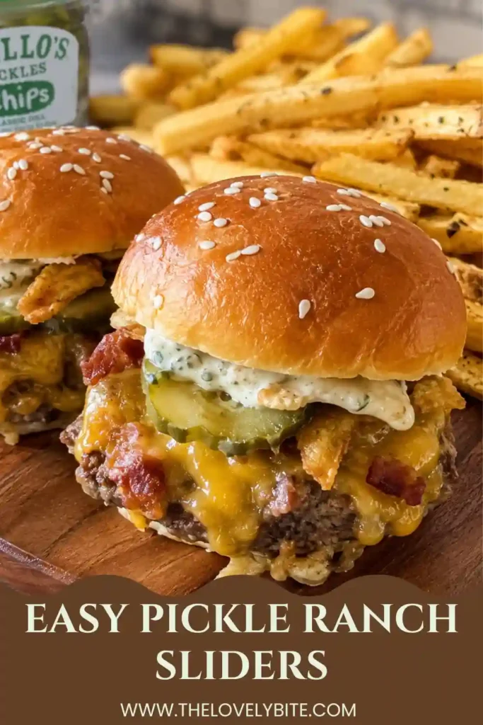 Close-up of Pickle Ranch Sliders filled with juicy seasoned beef, American and Colby Jack cheese, dill pickles, and creamy ranch sauce. Soft Hawaiian rolls are brushed with butter and topped with sesame seeds.