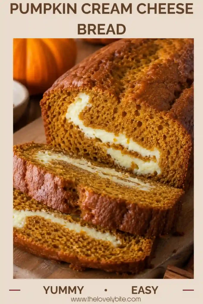 A thick slice of Pumpkin Cream Cheese Bread served beside a cup of coffee, showing its moist texture and creamy filling. The loaf is flavored with cinnamon, cloves, and pumpkin pie spice.