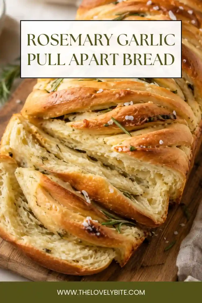 Homemade rosemary garlic bread baked in a loaf pan with layered dough, garlic butter, herbs, and melted cheese. Fresh rosemary decorates the golden pull apart loaf.