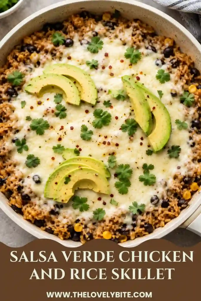 Salsa verde chicken and rice skillet served warm with melted cheese, chopped cilantro, avocado, and red pepper flakes. The colorful one-pan meal features tender chicken, seasoned rice, black beans, and roasted corn.