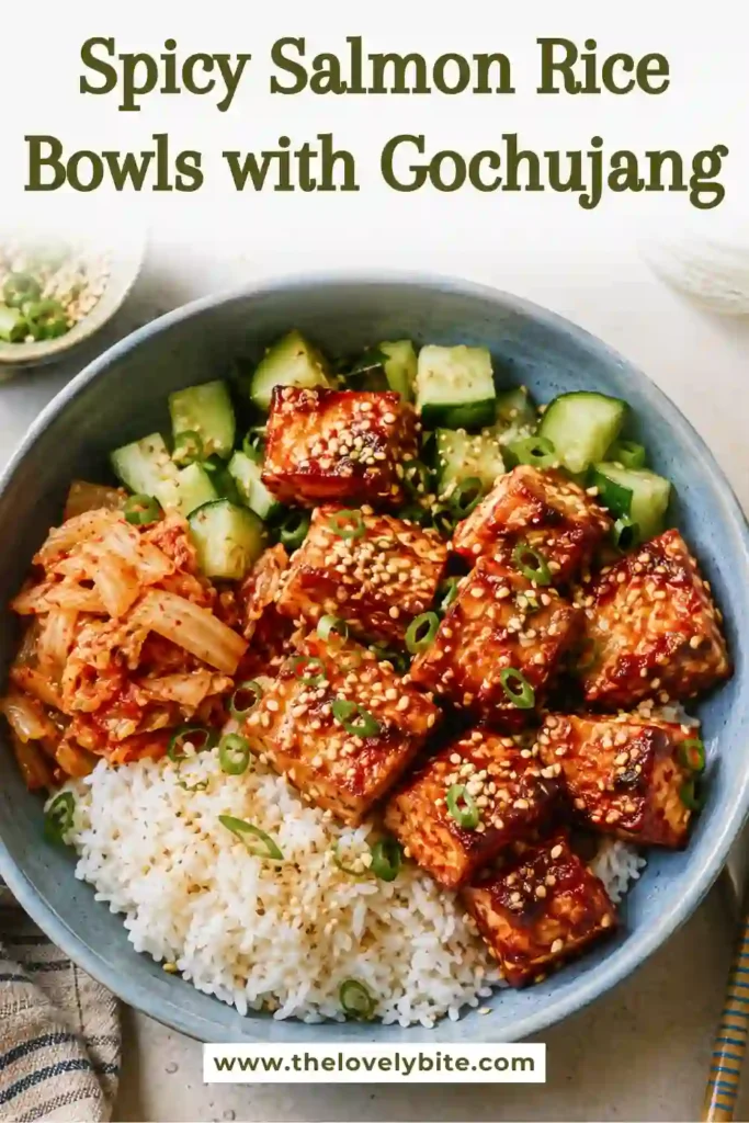 Gochujang salmon bites served over warm sticky rice with chopped cucumber and kimchi. This spicy salmon bowl combines savory, spicy, fresh, and tangy flavors.