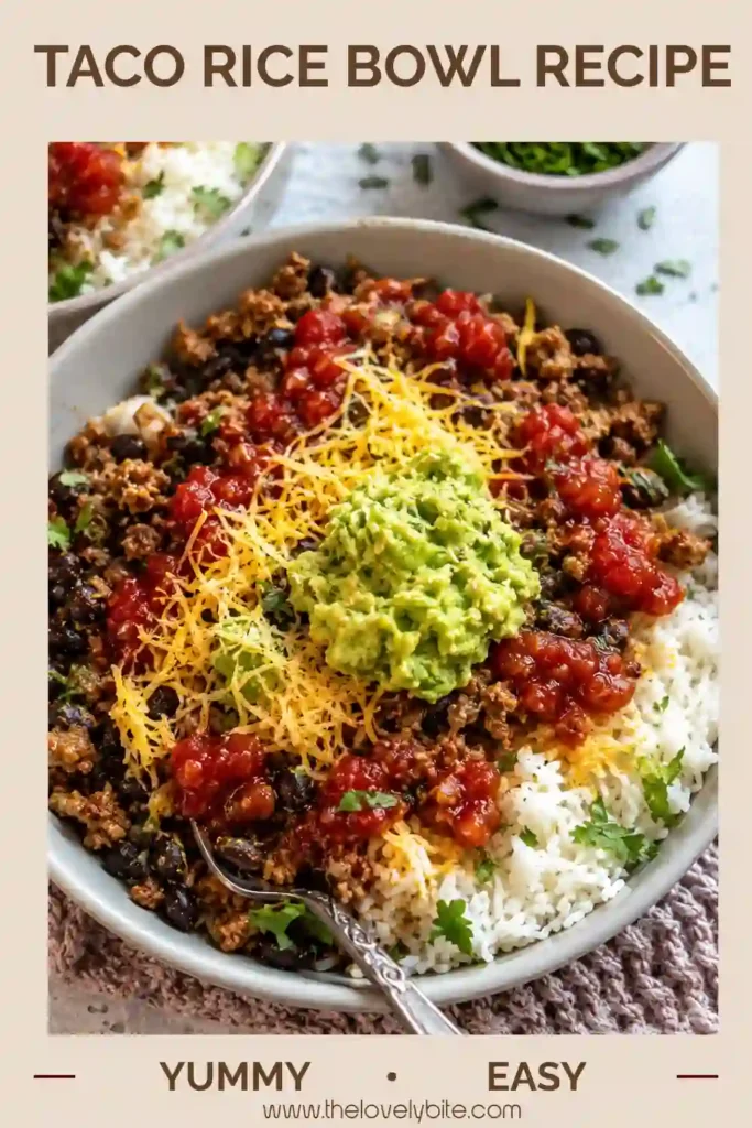 A hearty Taco Rice Bowl filled with seasoned ground beef, fluffy white rice, black beans, fresh guacamole, salsa, and shredded cheese. This colorful Mexican-inspired meal is perfect for an easy weeknight dinner.