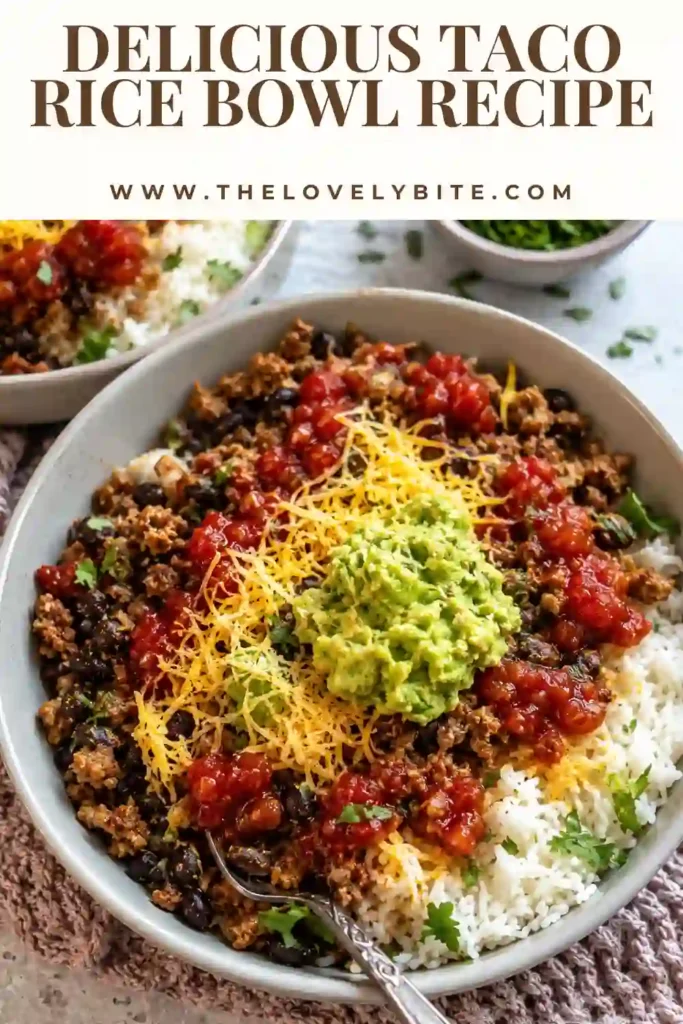 Ground beef Taco Rice Bowl served with white rice, black beans, salsa, cheese, cilantro, and homemade guacamole. A colorful and protein-packed family dinner.