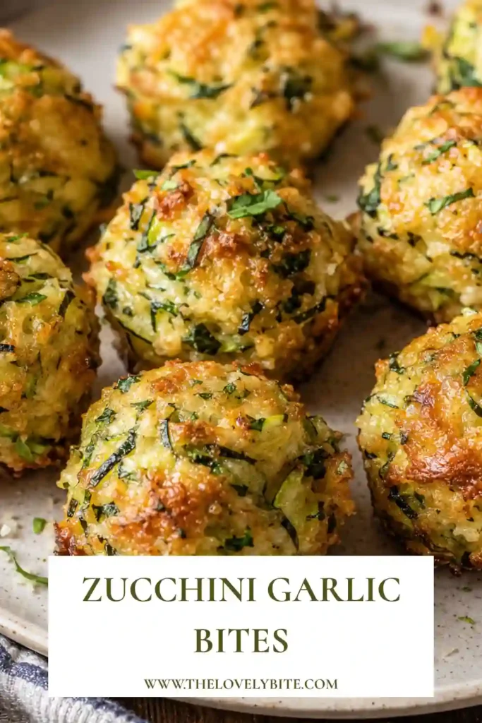 Zucchini Garlic Bites baked until golden with shredded zucchini, Parmesan cheese, garlic, breadcrumbs, and fresh herbs. The crispy zucchini bites are served warm with marinara sauce.