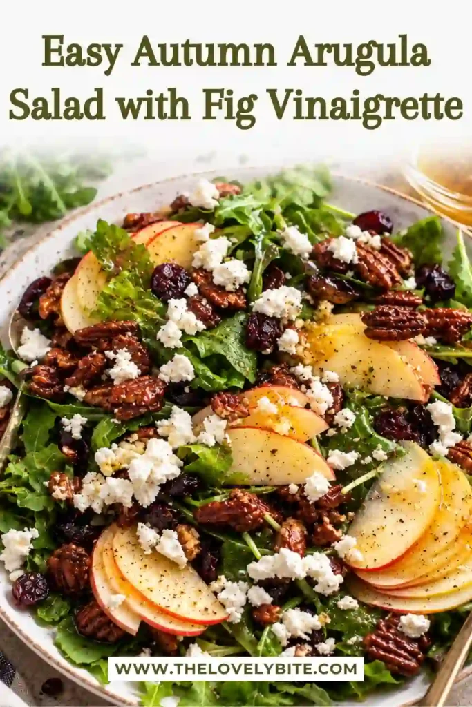 Fresh fall arugula salad with crisp apple slices, creamy goat cheese, dried fruit, and caramelized spiced pecans. The salad is finished with homemade fig vinaigrette.