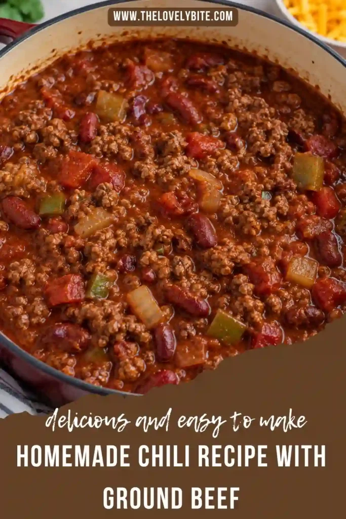 A hearty bowl of homemade ground beef chili served alongside golden cornbread. Cheddar cheese, sour cream, and fresh green onions complement the rich chili with beans.