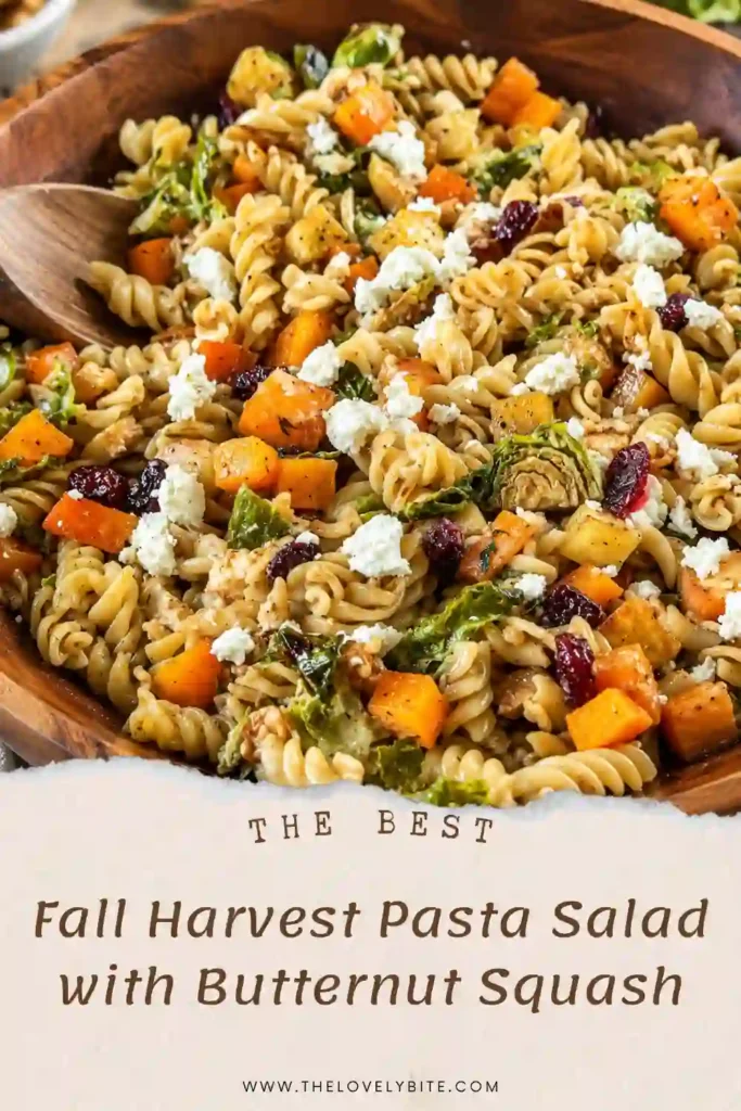 Thanksgiving pasta salad made with rotini, roasted butternut squash, Brussels sprouts, apple, goat cheese, and dried cranberries. The seasonal pasta salad is tossed with homemade maple Dijon vinaigrette.