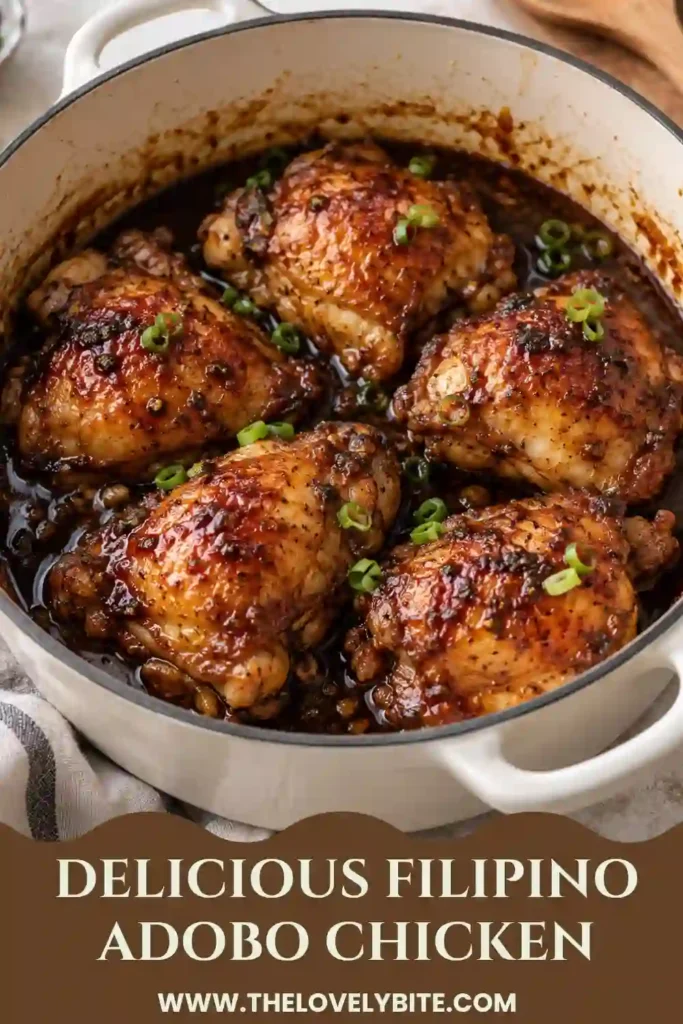 A serving of Filipino chicken adobo featuring juicy chicken thighs in a dark, savory sauce. The classic soy sauce, vinegar, garlic, and pepper combination gives the dish its distinctive flavor.