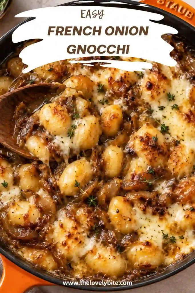 A comforting serving of French Onion Gnocchi with golden melted cheese, caramelized onions, and fresh thyme. The dish features tender potato gnocchi in a rich savory onion sauce.