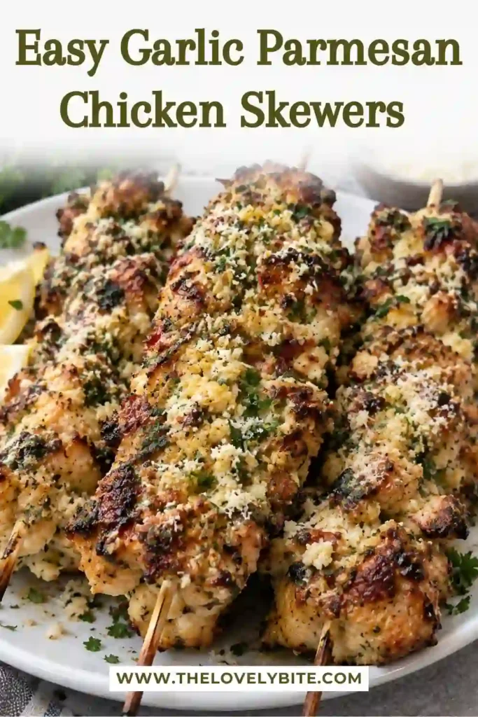 Garlic butter chicken skewers served with fluffy rice and roasted vegetables. The chicken is coated in Parmesan garlic butter sauce and garnished with fresh parsley.