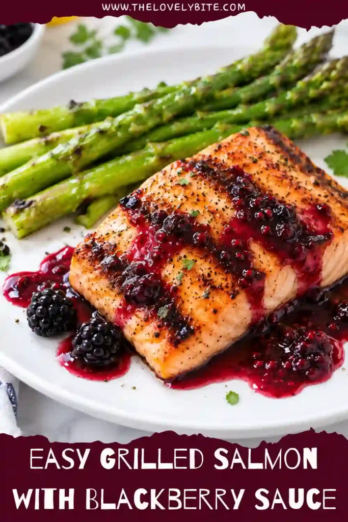 Close-up of blackberry salmon topped with homemade blackberry sauce and served with fresh green vegetables. The grilled salmon has a lightly browned surface and a moist, flaky texture.
