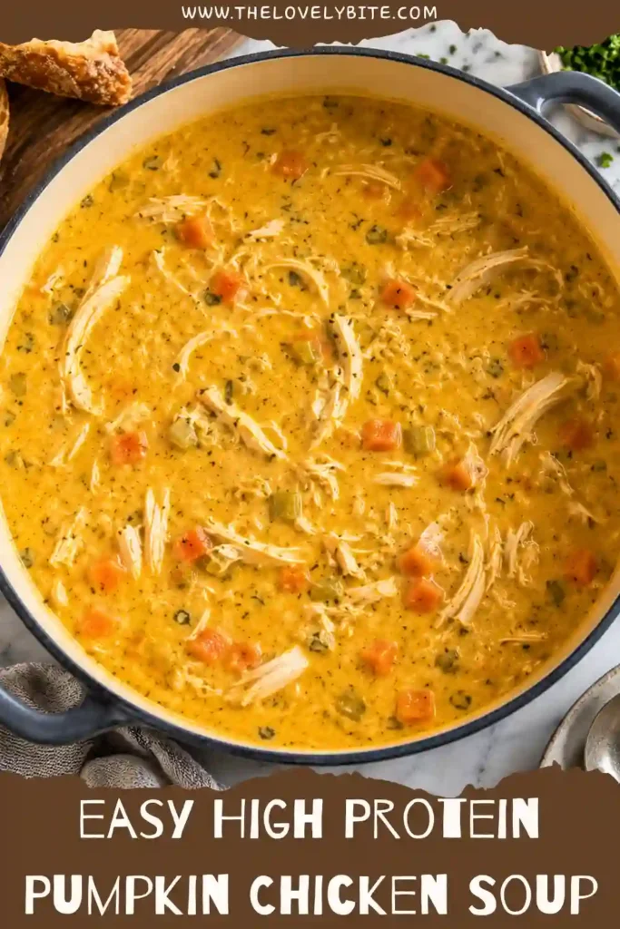 Creamy pumpkin soup with chicken served in a bowl, featuring a rich golden color and tender shredded chicken. Carrots, celery, and herbs add color and savory flavor to this healthy chicken soup.