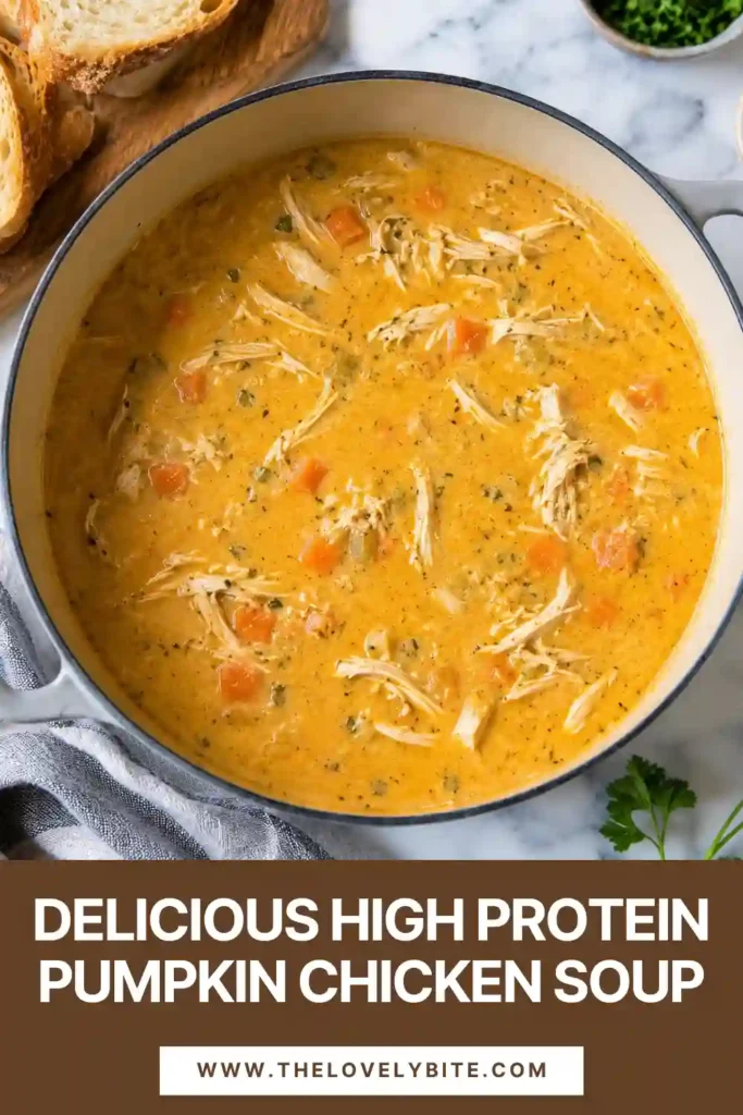 A comforting bowl of healthy chicken soup made with pumpkin puree, shredded chicken, carrots, celery, and Greek yogurt. The smooth orange soup is topped with herbs and served as a nourishing fall dinner.