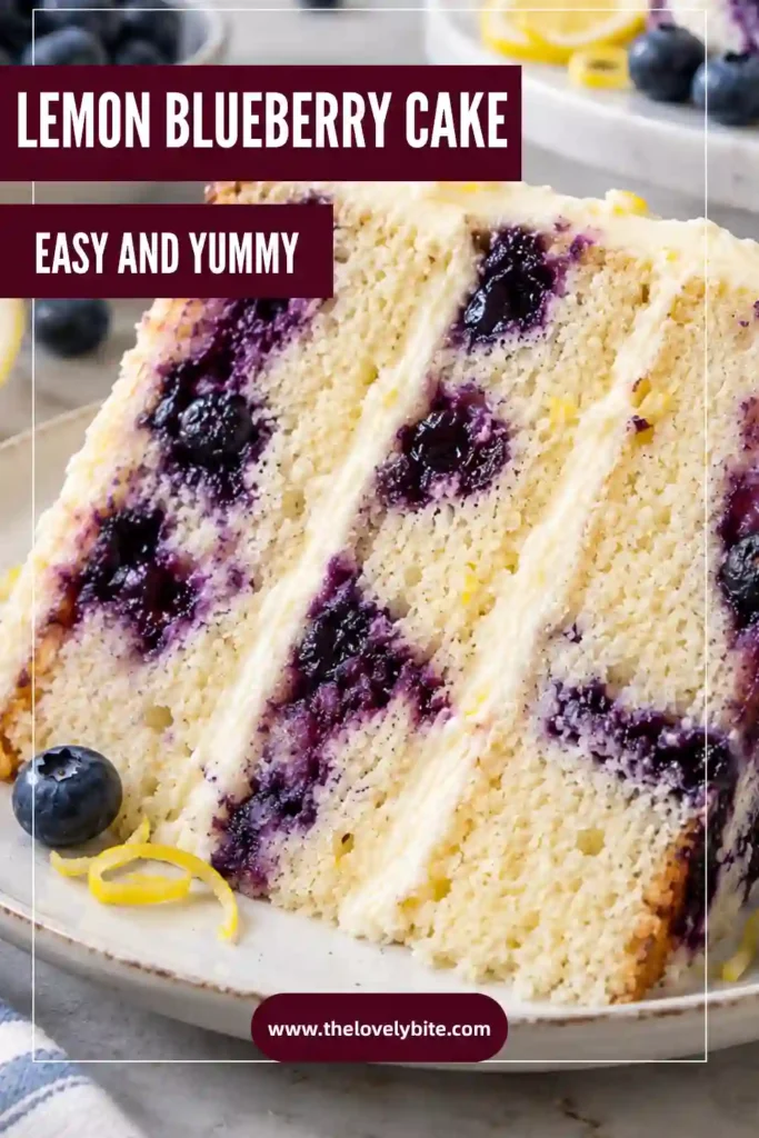 A slice of Lemon Blueberry Cake showing juicy blueberries throughout a soft, tender crumb. The cake is topped with creamy lemon cream cheese frosting and fresh blueberries.