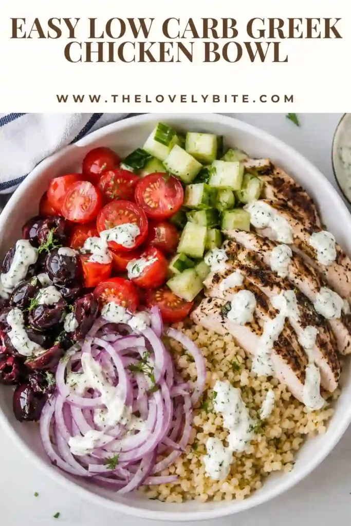 A Mediterranean chicken bowl packed with Greek-marinated chicken, cauliflower rice, cucumber, tomatoes, Kalamata olives, feta cheese, and tzatziki. Fresh herbs and lemon provide a colorful finishing touch.