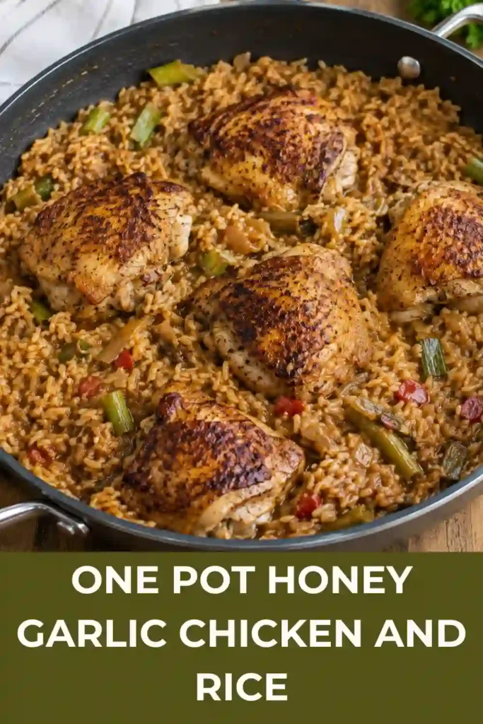 One Pot Honey Garlic Chicken and Rice shown from above in an oven-safe skillet. Crispy chicken thighs, fluffy rice, green onions, and sesame seeds create a hearty family dinner.