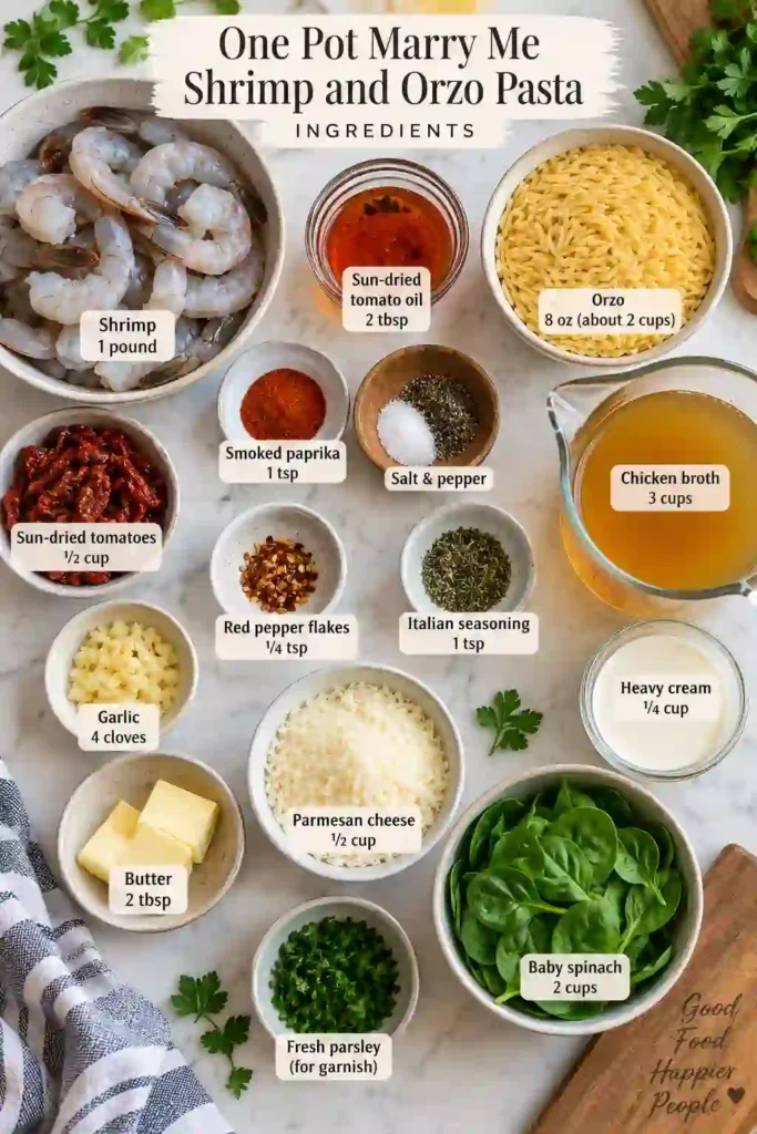 A skillet filled with One Pot Marry Me Shrimp and Orzo Pasta, showing tender shrimp over creamy orzo with spinach and sun-dried tomatoes. Fresh parsley and Parmesan garnish the finished dish.